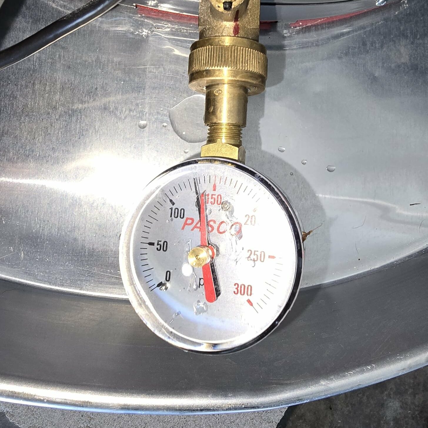 A pressure gauge showing a high water pressure reading of 133psi